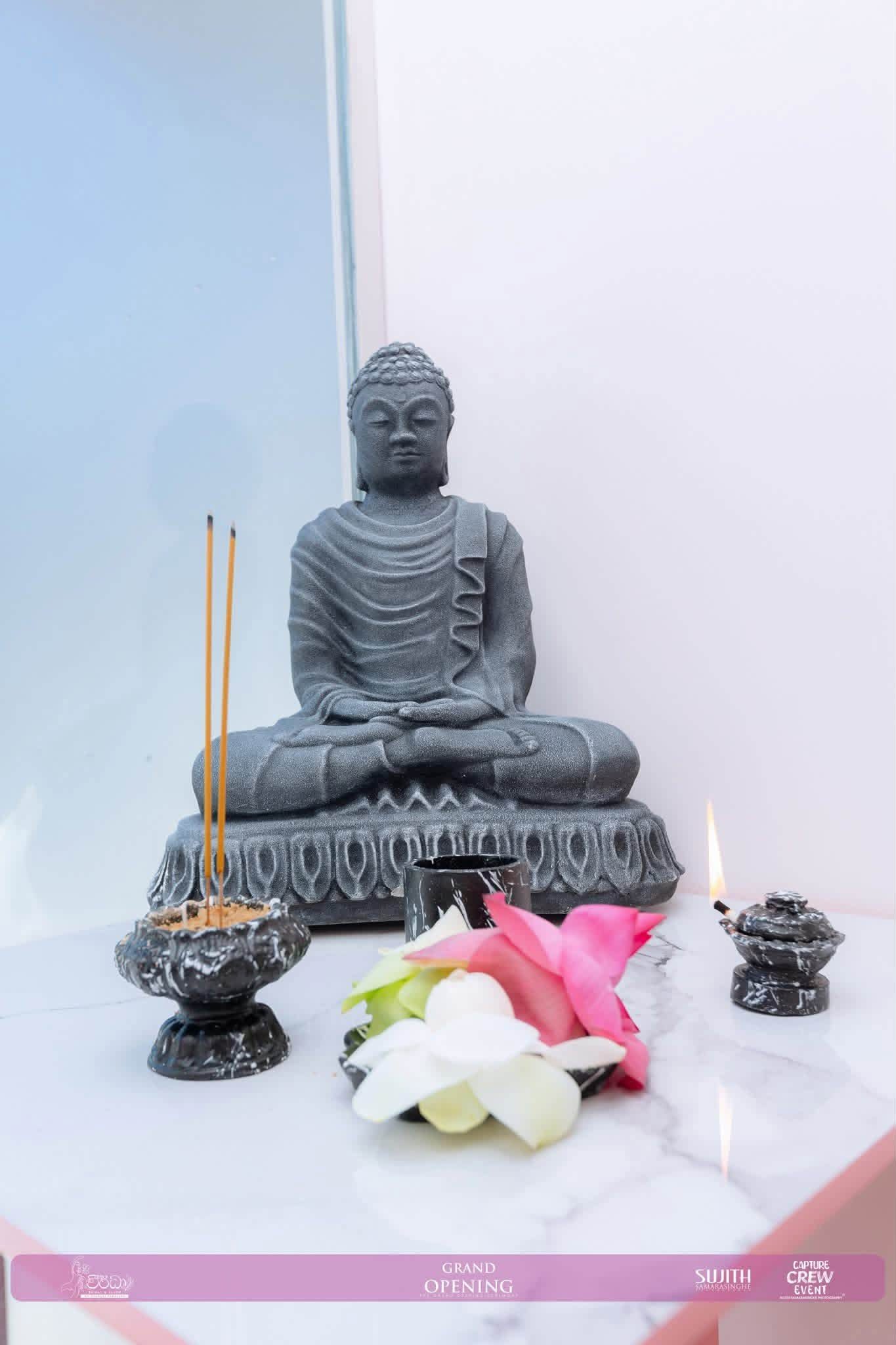 The shrine corner of the studio, with flowers and incense